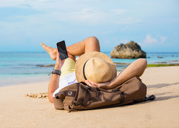 Man with phone on the beach